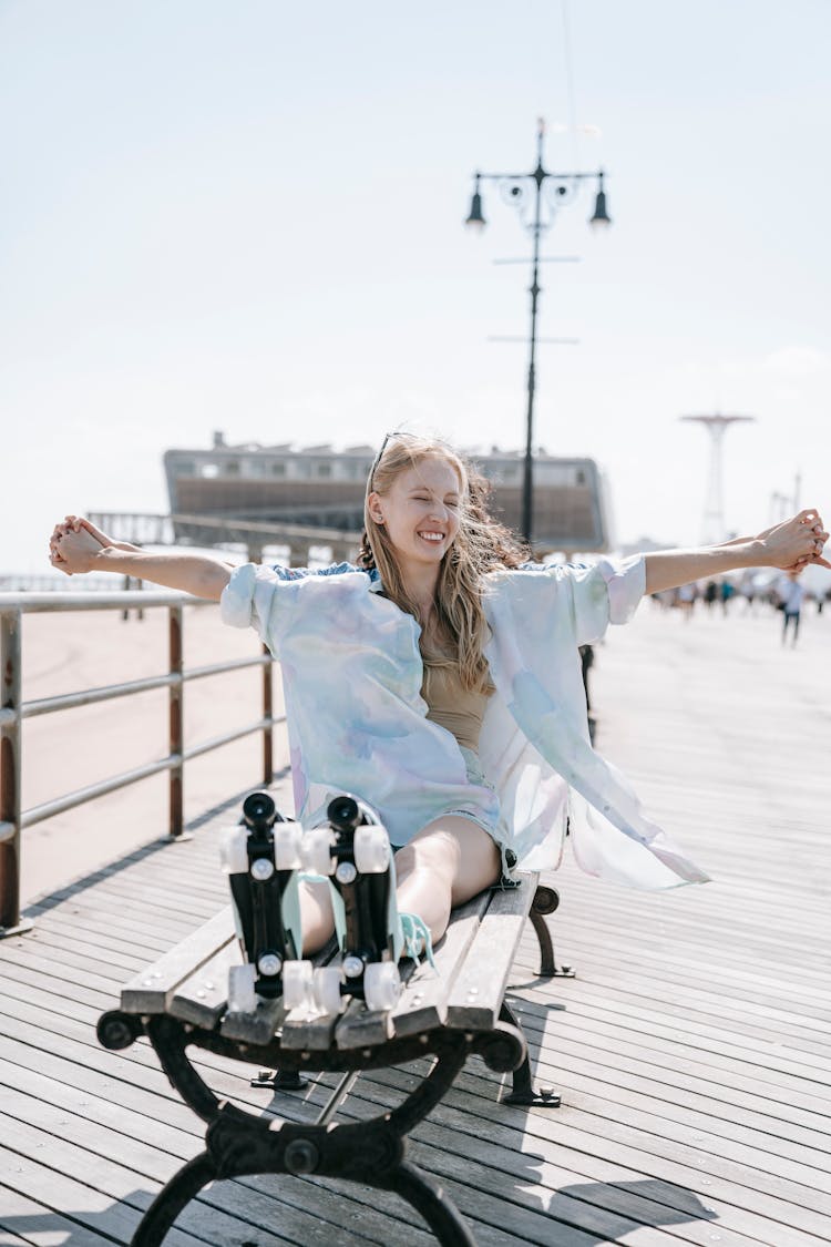 Happy Girl In Rollers Relaxing On Beach