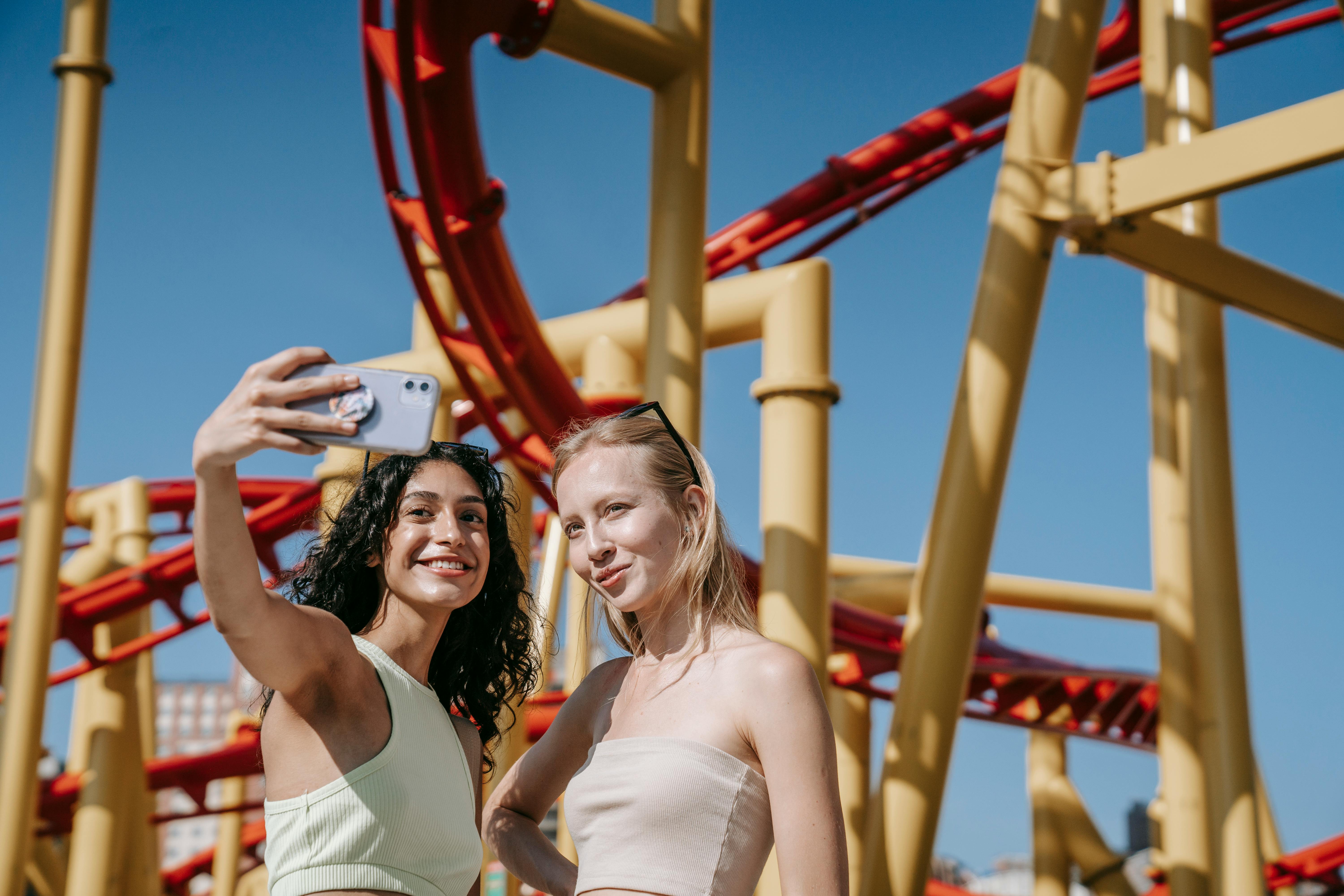 woman in green tank top taking a selfie