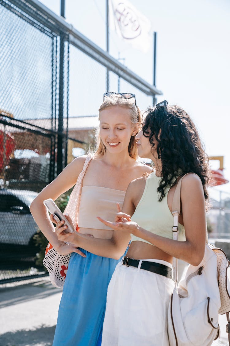 A Woman Showing Her Friend Her Cellphone