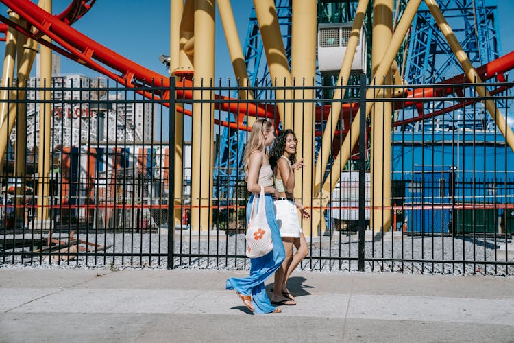 Stylish Women Walking On The Sidewalk