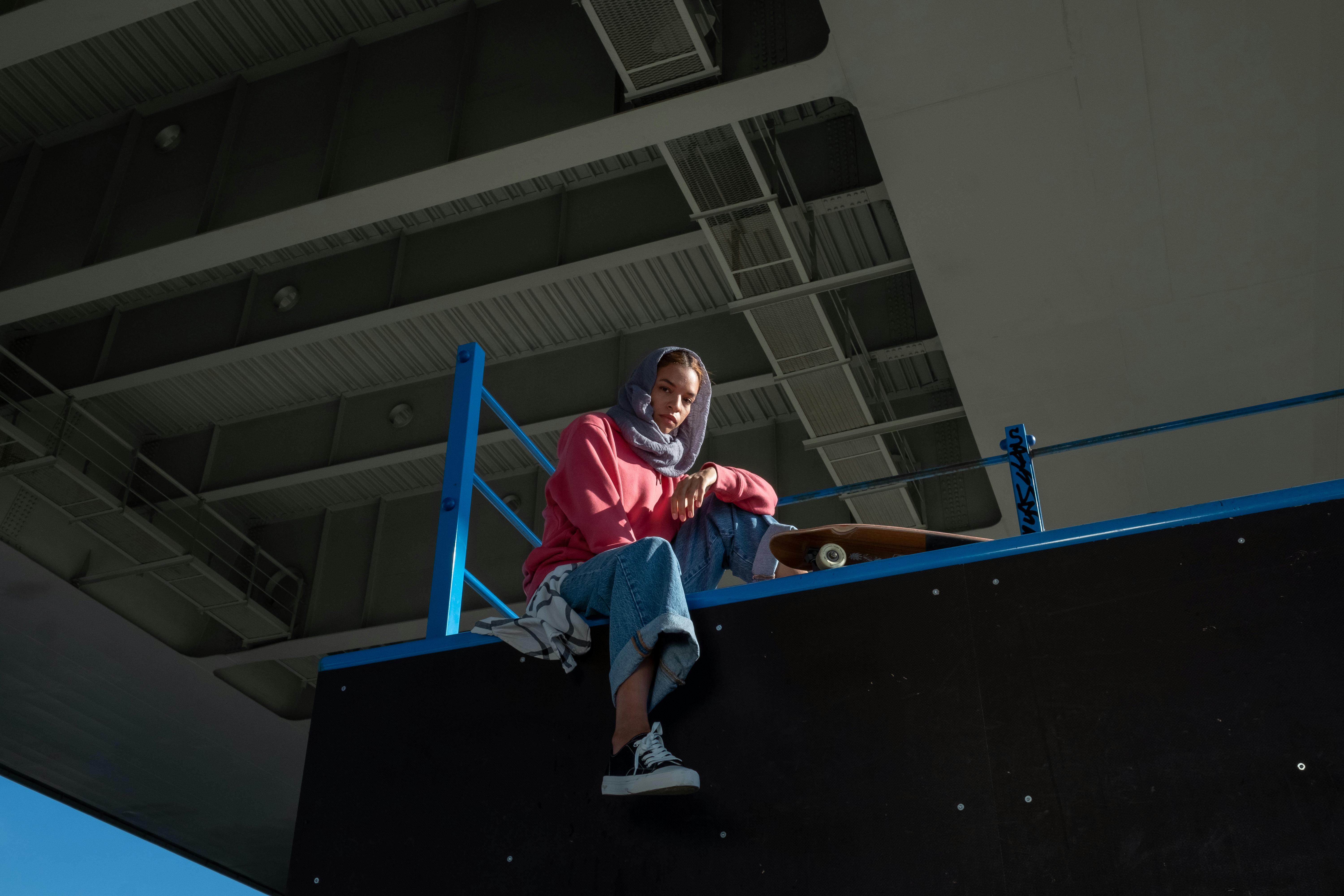 a woman sitting on the edge of a ramp