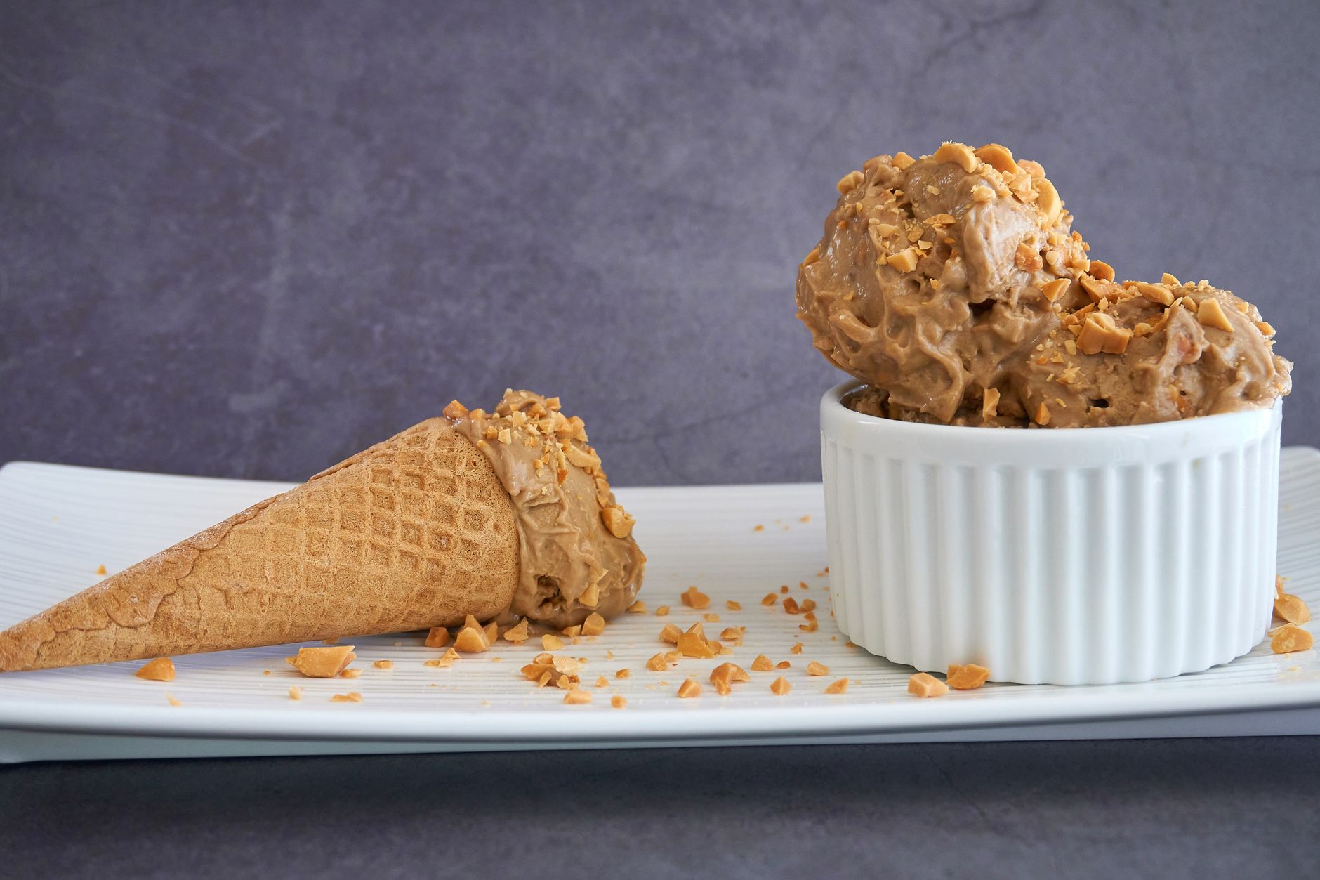 Scoop of rich chocolate peanut butter ice cream with peanut butter swirl