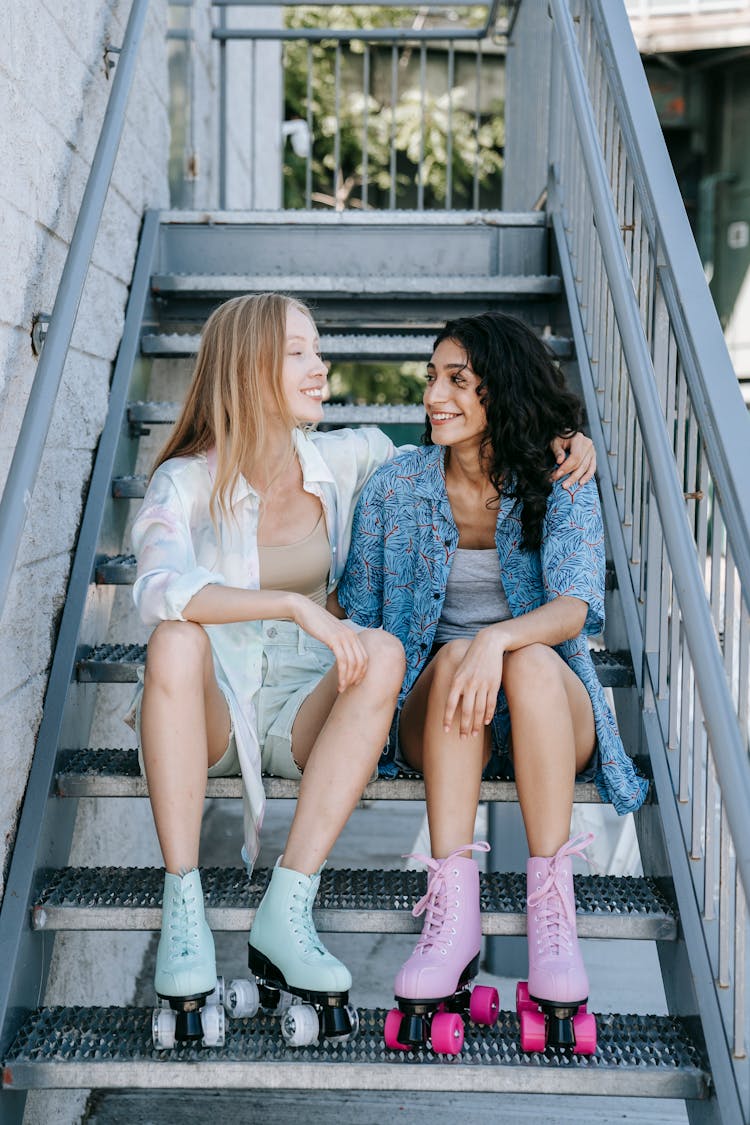 Friends In Roller Skates Sitting On A Flight Of Stairs