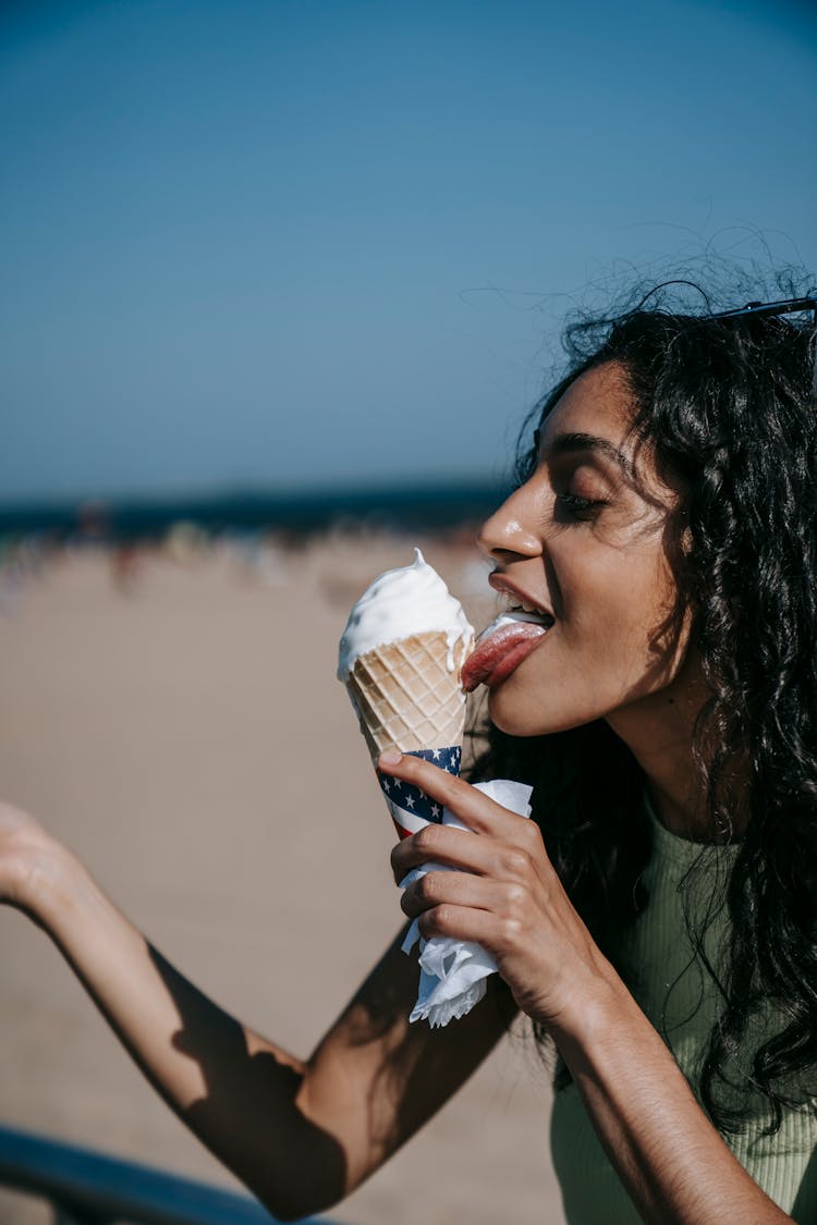 A Woman Licking An Ice Cream