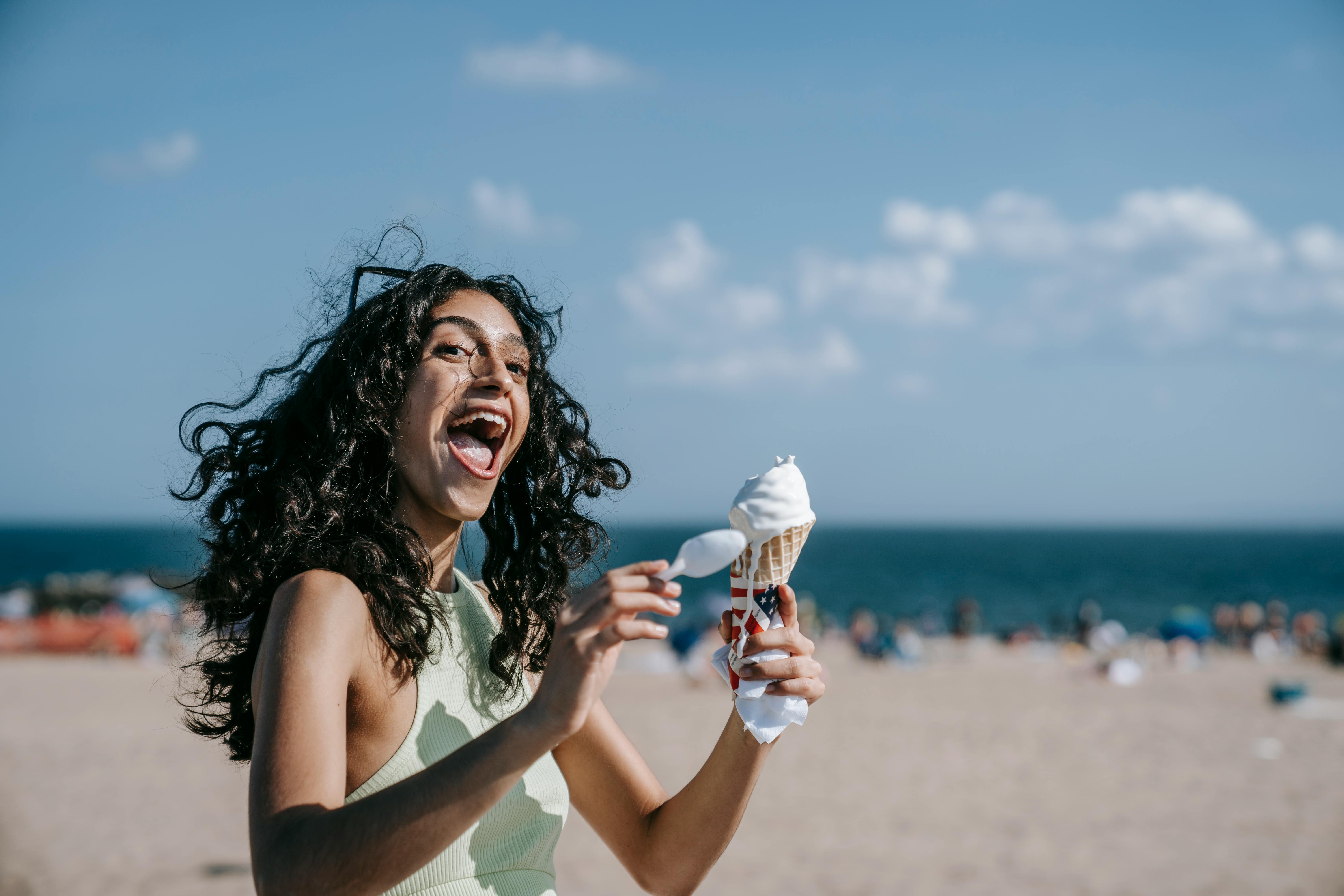 a happy woman holding ice cream