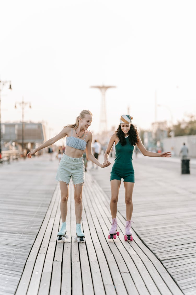 Women Rollerskating Together On Promenade