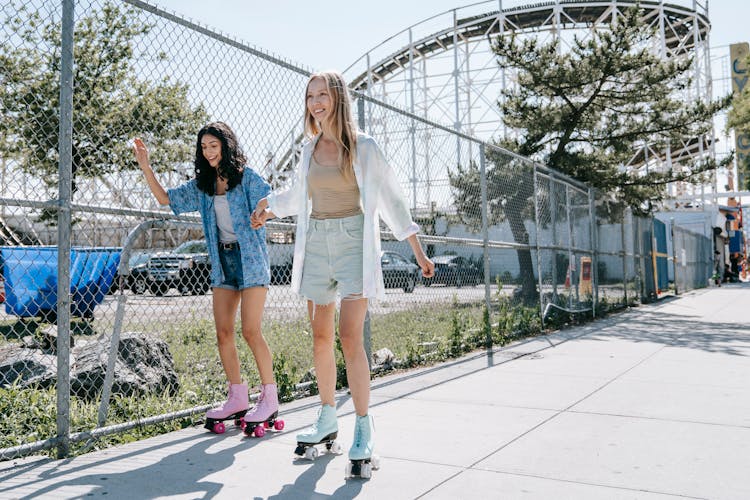 Women Rollerskating On Pavement