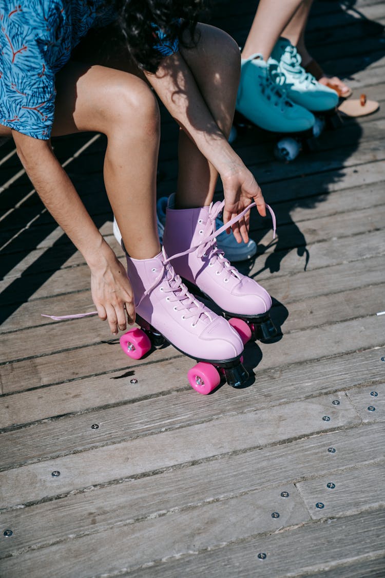 Women Tying Roller Skates