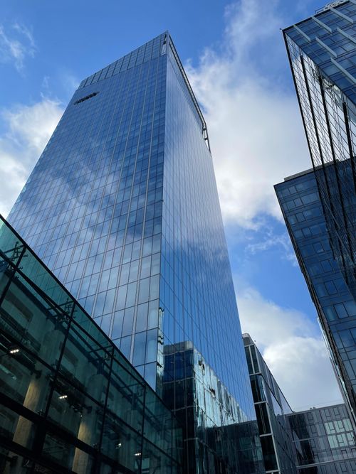 Free Modern glass skyscrapers reflecting a bright blue sky in Gdańsk, Poland. Stock Photo