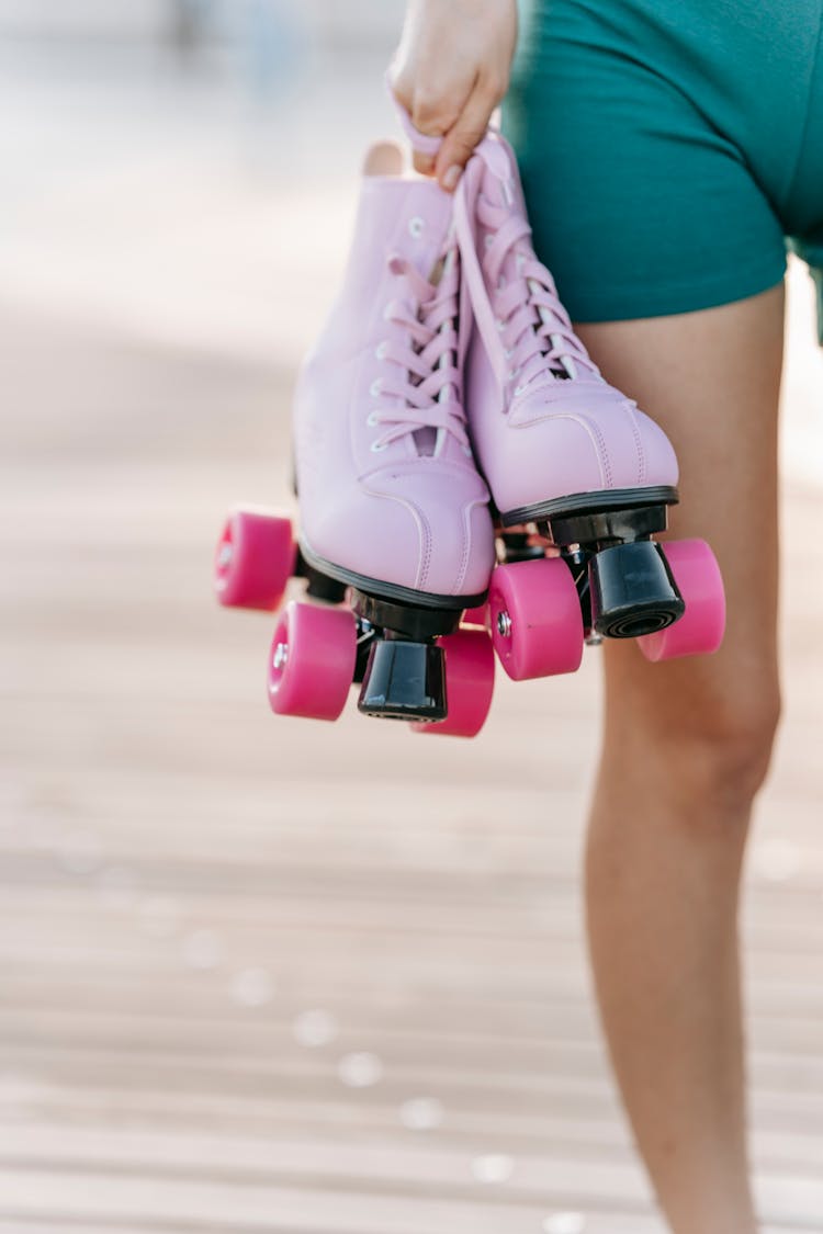 A Person Holding A Roller Skates