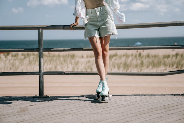 Woman In Shorts With Roller Skates On Pavement