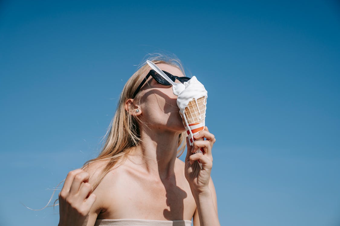 Woman Eating Melting Ice Cream