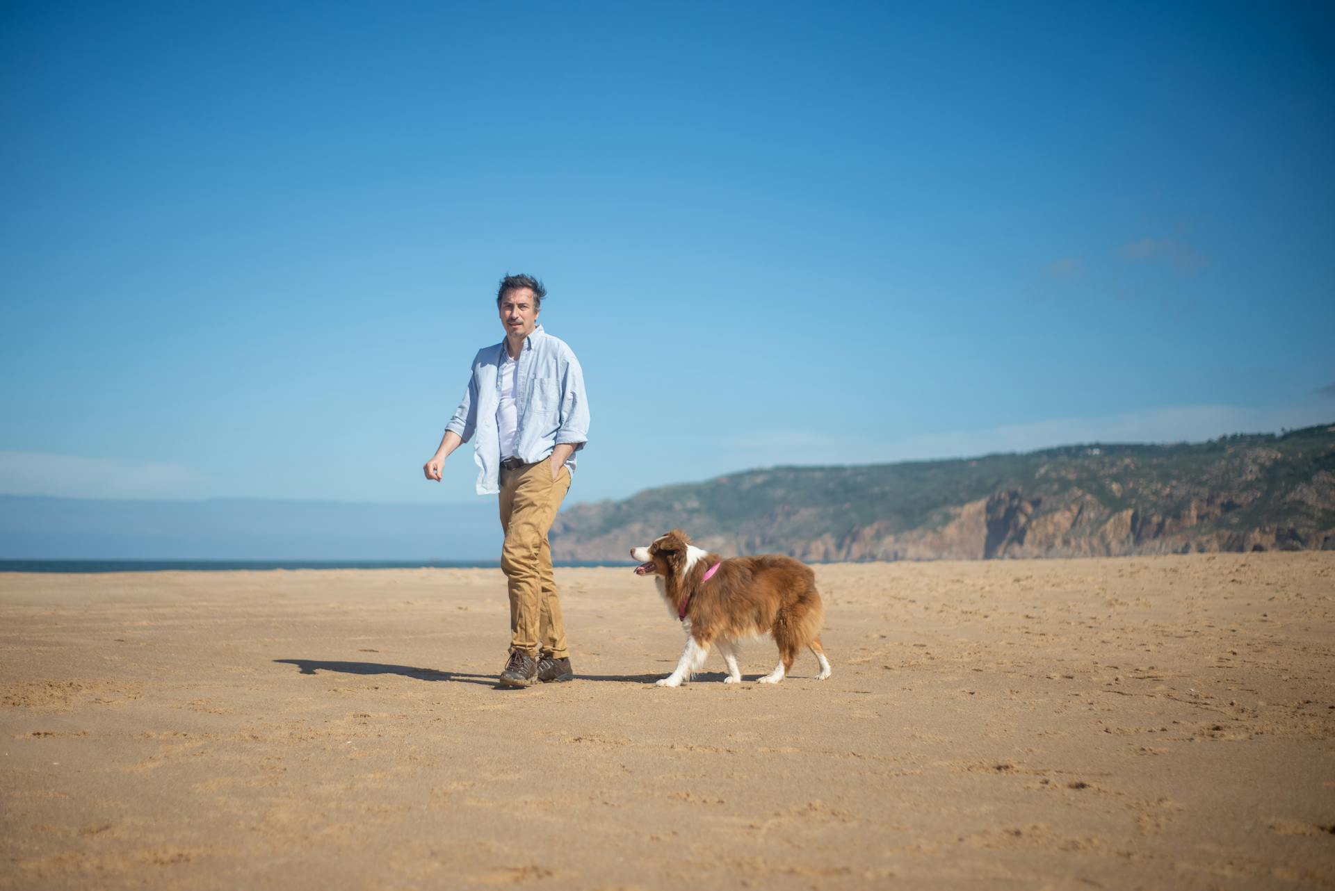 A Man Walking Together with his Pet Dog