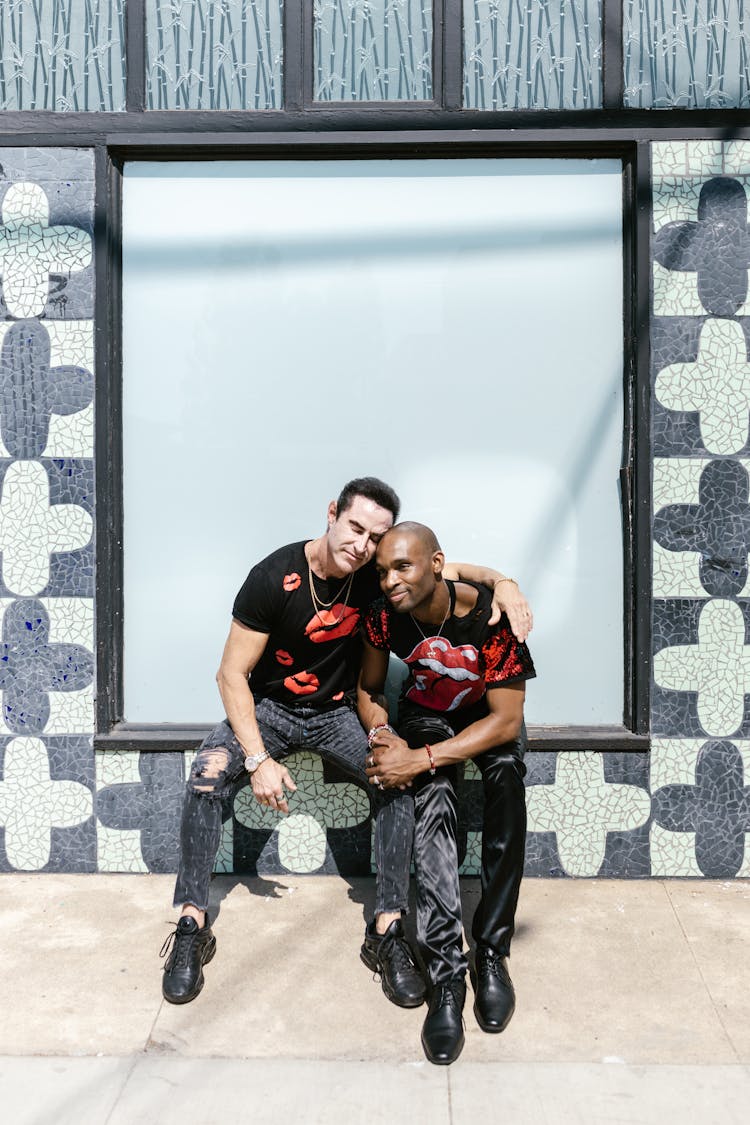 Men In Black Shirt Sitting On Window Sill