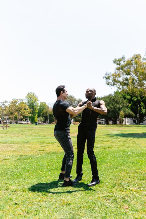 Free Two men enjoying a dance in a sunny park, symbolizing love and diversity. Stock Photo
