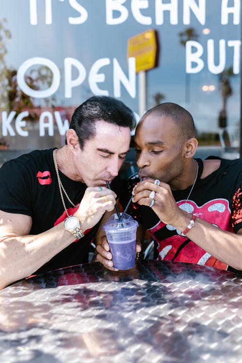 A Male Couple Sharing a Drink Together