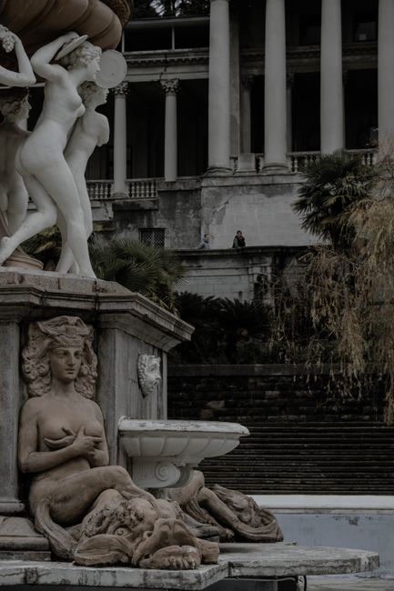 Intricate neoclassical statues adorn the courtyard of an old building in Sochi, Russia.