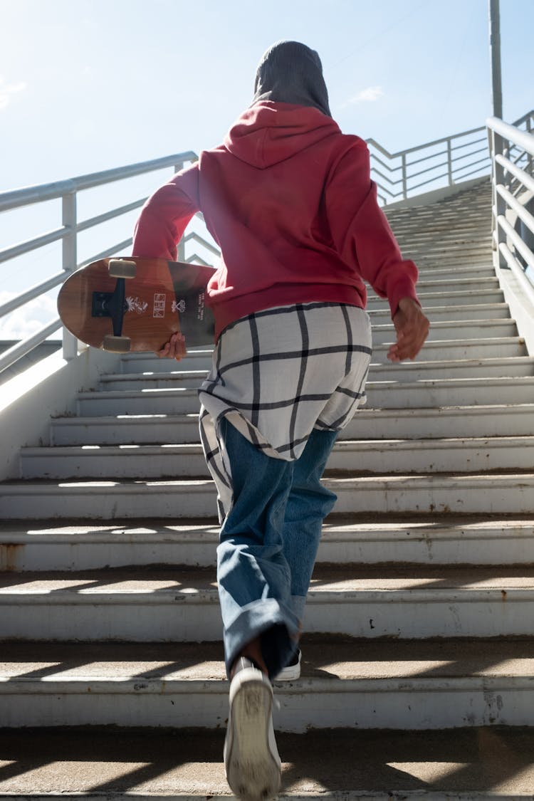 Back View Of A Person Walking On The Staircase
