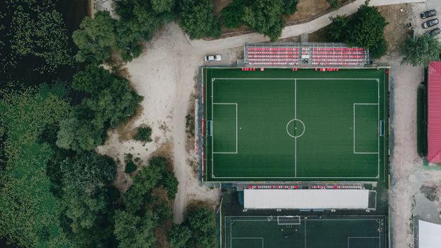 Drone image showcasing a soccer field surrounded by lush greenery in Kyiv, Ukraine.