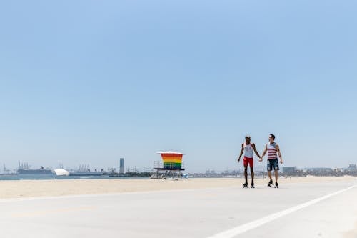 Men Holding Hands While Roller Skating