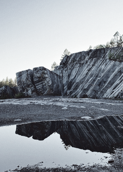 Free A stunning view of the marble cliffs reflecting in a puddle at Ruskeala, Karelia, Russia. Stock Photo