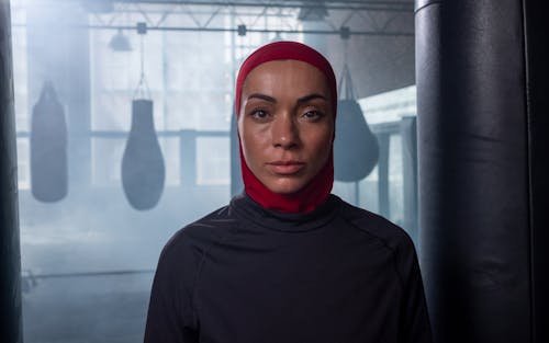 Woman in Red Hijab and Black Shirt in Gym