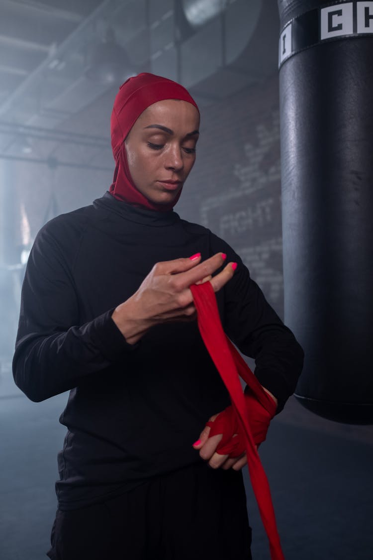 A Woman In Red Hijab Wearing Hand Bondage