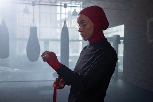 A Woman in Red Hijab Wearing Hand Bondage