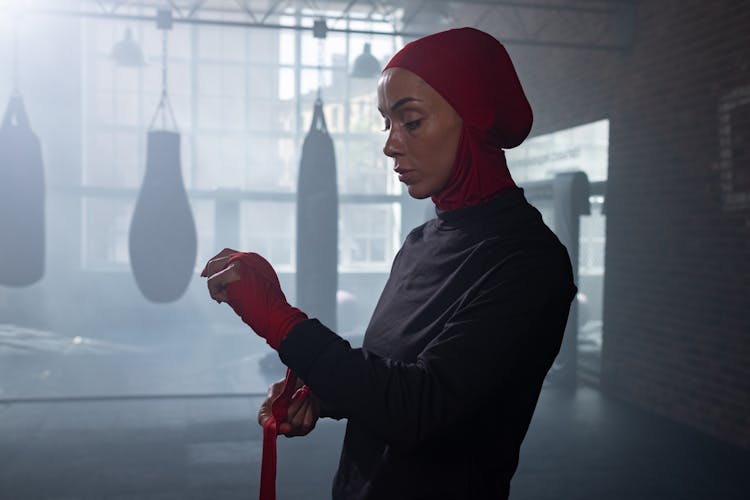 A Woman In Red Hijab Wearing Hand Bondage