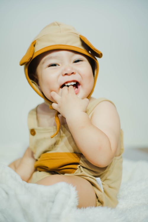 Free Close-Up Photo of a Cute Kid with His Fingers in His Mouth Stock Photo