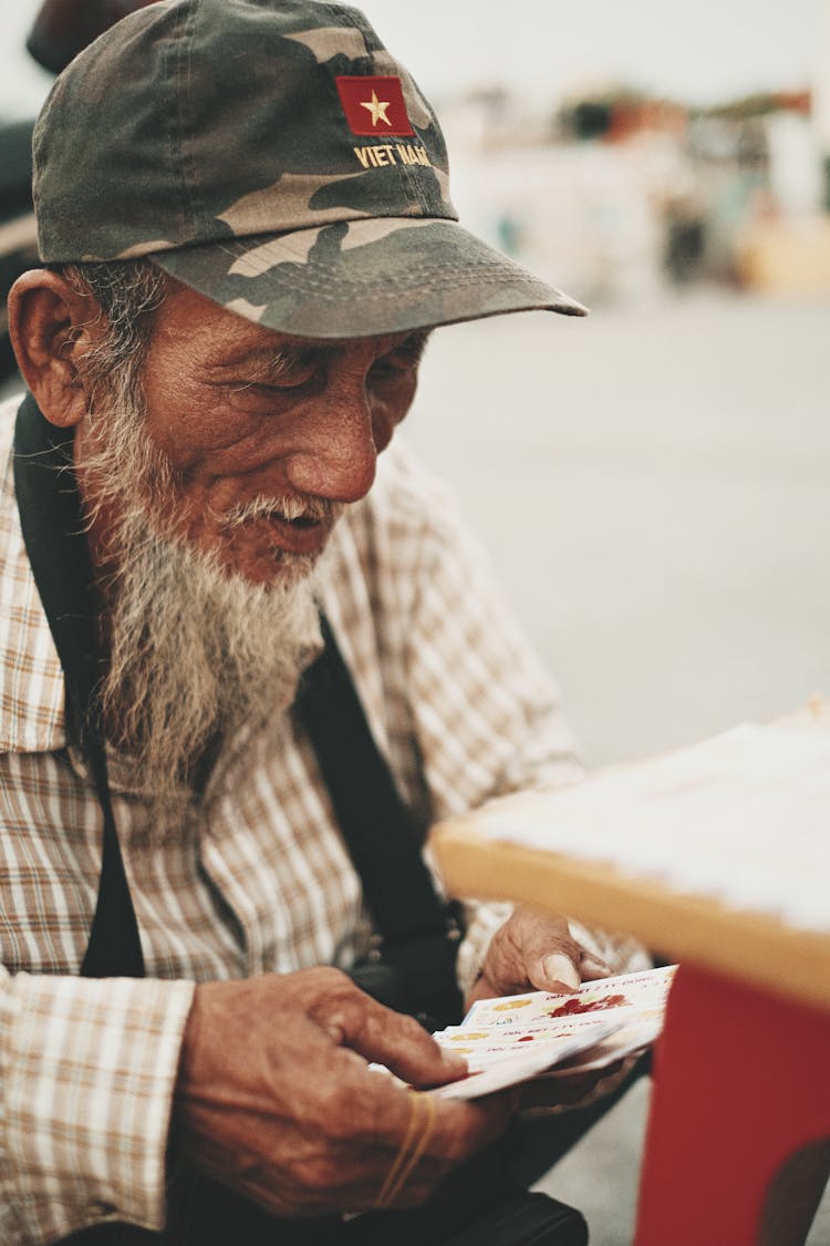 An Elderly Man Holding Tickets