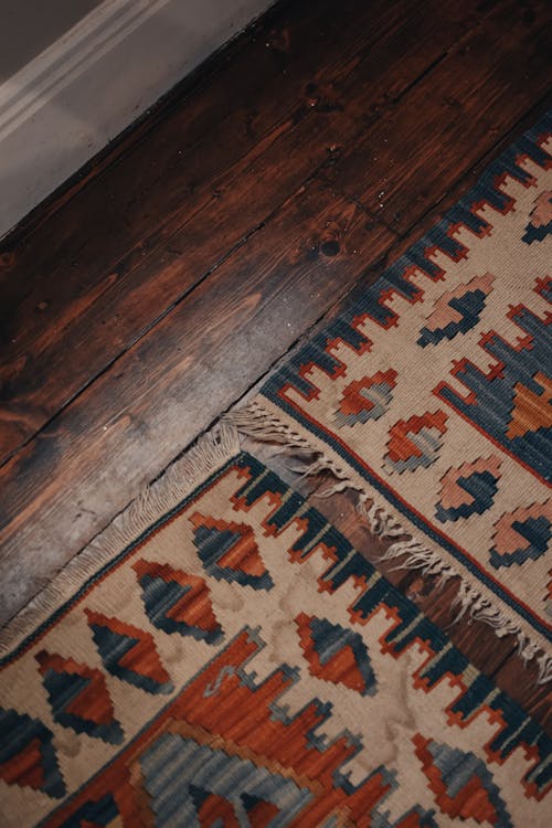 Close-Up Shot of Rugs on a Wooden Floor