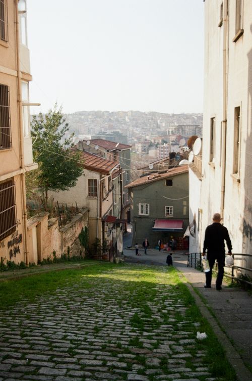 Free Explore the charm of Istanbul's cobblestone streets on a sunny day, featuring historic architecture. Stock Photo
