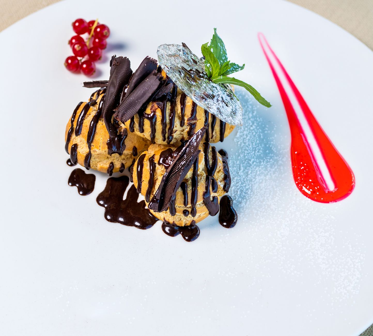 Classic cream puffs with glossy chocolate sauce