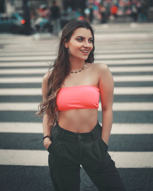 A Sexy Woman Standing on Pedestrian Lane