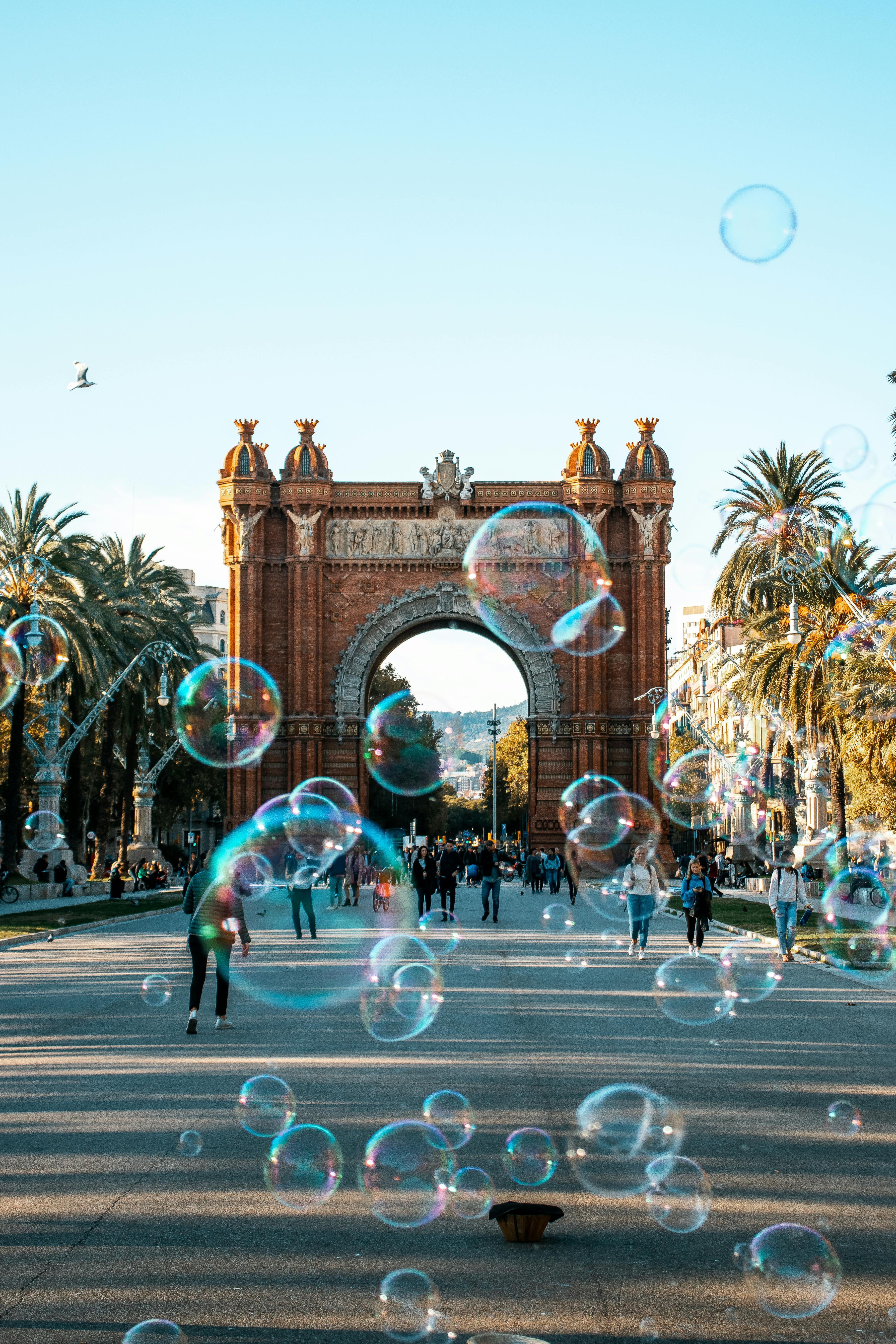 people walking on the street with bubbles
