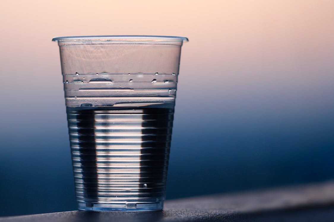 Clear Plastic Cup on Gray Surface