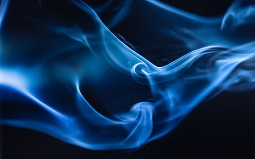 Free Abstract blue smoke swirls against a dark background. Captivating and moody. Stock Photo