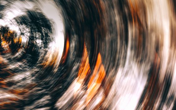 Swirling abstract image with vibrant colors creating a vortex effect, symbolizing motion and energy.