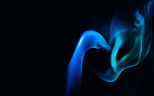 Free Mesmerizing blue smoke swirl on a dark background, showcasing fluid movement and ethereal beauty. Stock Photo