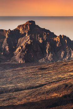 Stunning view of Mount Teide with a warm sunset glow, capturing the volcanic landscape in Tenerife, Spain.