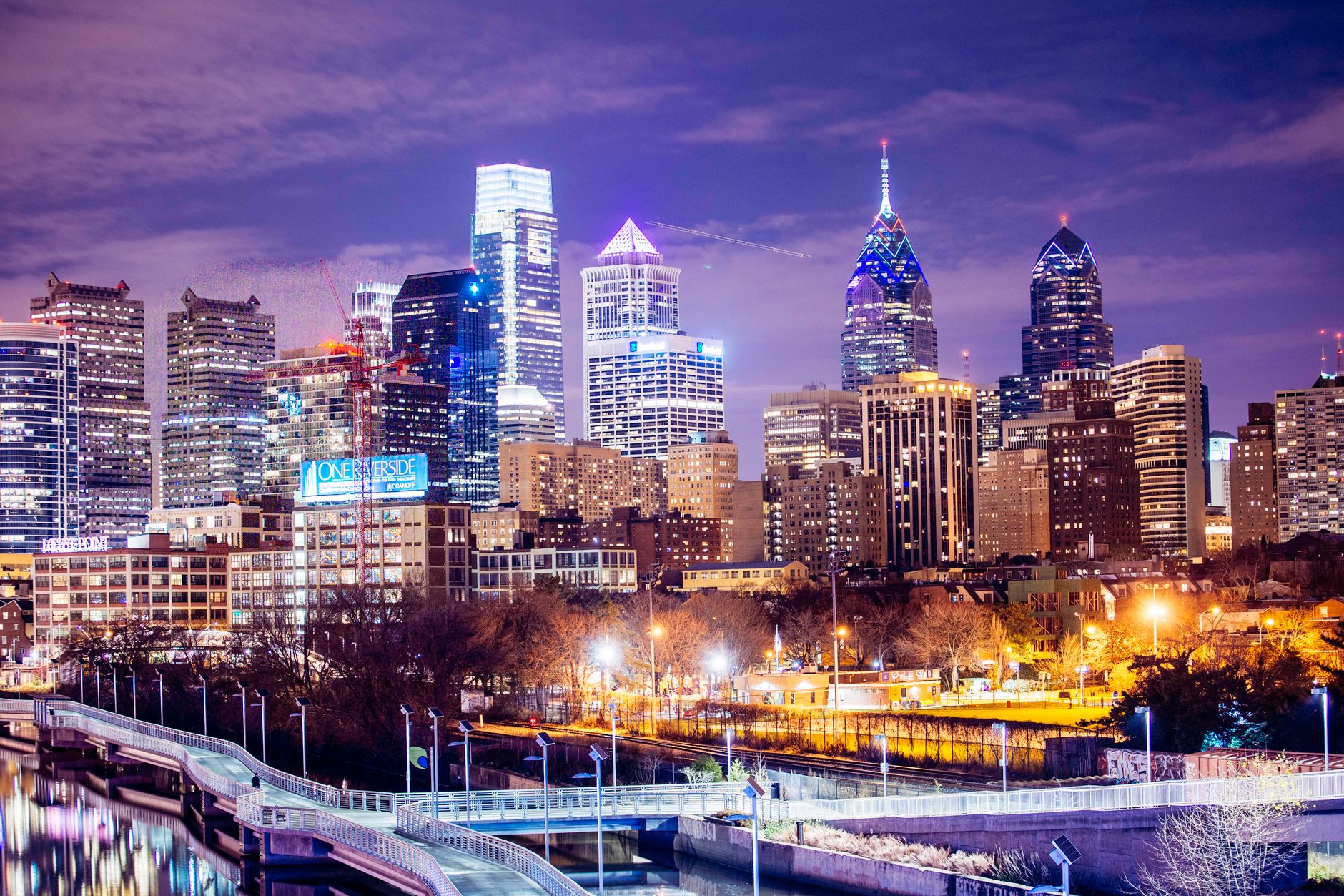 A vibrant view of Philadelphia's illuminated skyline at night showcasing modern skyscrapers.