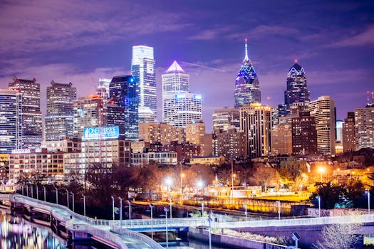 A vibrant view of Philadelphia's illuminated skyline at night showcasing modern skyscrapers.