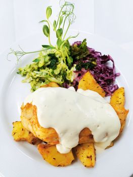 Delicious chicken breast with creamy sauce and vegetables, perfect for gourmet dining.