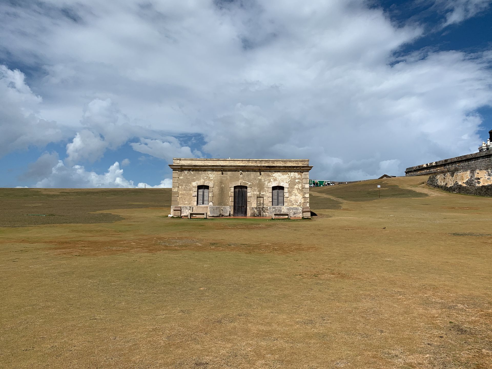 Old stone building under a cloudy sky in San Juan's historic site.