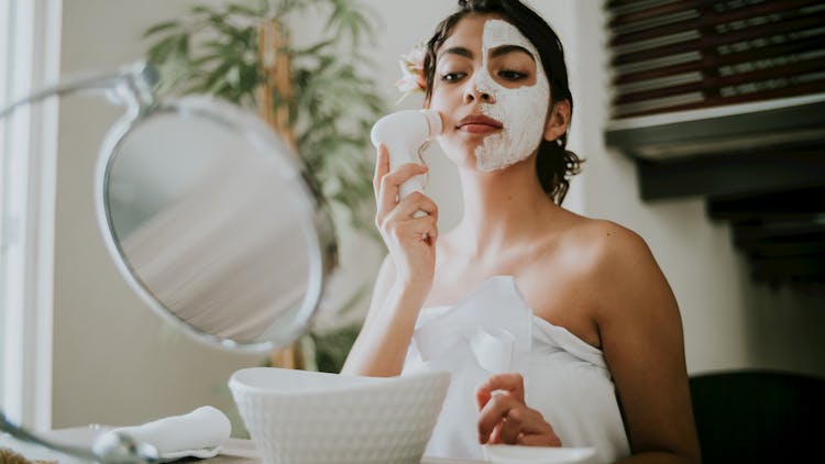 Woman In White Tube Top Holding White Facial Cleanser