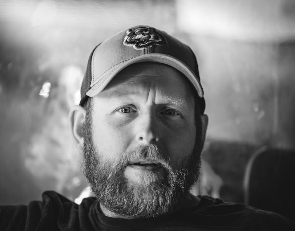 Monochrome Photo of a Man with Facial Hair Wearing a Baseball Cap