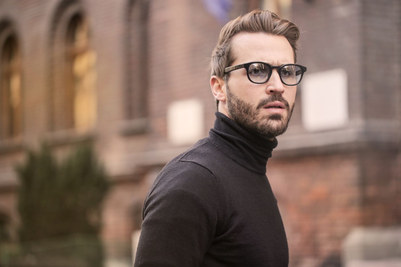 Retrato editorial de un hombre con gafas y jersey de cuello alto