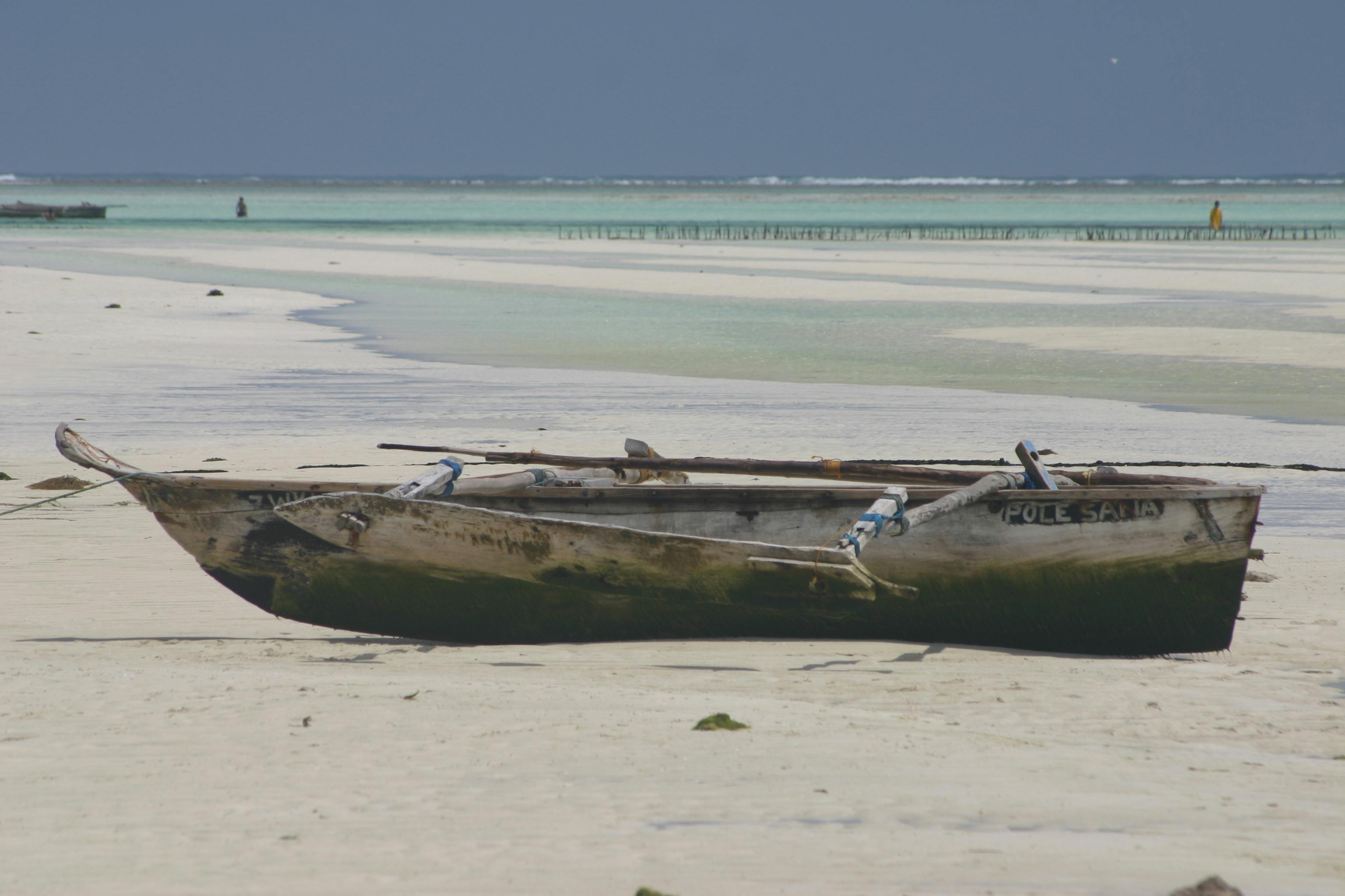 Free stock photo of Firsherman\'s canoe at low tide on white sand beach