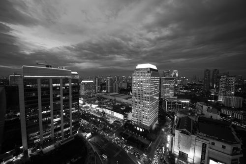 Free Aerial view of Jakarta's skyline at night showcasing iconic skyscrapers in black and white. Stock Photo